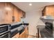 The kitchen is equipped with wooden cabinets, black countertops, and modern appliances for cooking at 108 W Byers Pl # 106, Denver, CO 80223