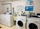 A bright laundry room with multiple washers and dryers for resident convenience and ease at 108 W Byers Pl # 106, Denver, CO 80223