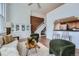 This living room has cozy chairs, exposed brick wall, open stairs, and a built in hutch at 108 W Byers Pl # 106, Denver, CO 80223