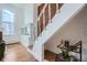 A staircase with red brick wall, white railing and newel post and wood floors at 108 W Byers Pl # 106, Denver, CO 80223