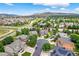 Aerial view shows a neighborhood setting with mature trees and mountain views at 14682 W Amherst Pl, Lakewood, CO 80228