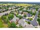 Aerial view showcases neighborhood with mature trees, community park, and sidewalks at 14682 W Amherst Pl, Lakewood, CO 80228