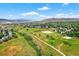 Aerial view shows park and trail system with views of the community and the mountains at 14682 W Amherst Pl, Lakewood, CO 80228