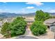 Aerial view shows home's placement on a cul-de-sac, mature trees, and mountain views at 14682 W Amherst Pl, Lakewood, CO 80228