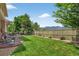 The home has a large lawn, a stone patio, perimeter landscaping and beautiful mountain views at 14682 W Amherst Pl, Lakewood, CO 80228