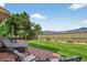 Spacious backyard with a well-maintained lawn, stone patio, and mountain views at 14682 W Amherst Pl, Lakewood, CO 80228