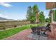 Backyard featuring a patio, lawn, and perimeter landscaping with flowers at 14682 W Amherst Pl, Lakewood, CO 80228
