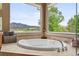 Tranquil bathtub area with a view of the mountains and greenery, set in a tiled nook with natural light at 14682 W Amherst Pl, Lakewood, CO 80228