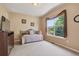 Cozy bedroom with a daybed, large window with nice view, and a dresser with a TV at 14682 W Amherst Pl, Lakewood, CO 80228