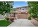 Charming two-story home with brick and siding, complemented by a well-manicured lawn and mature trees at 14682 W Amherst Pl, Lakewood, CO 80228