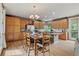 Large kitchen with wood cabinets, stainless steel appliances, center island, and dining area with seating at 14682 W Amherst Pl, Lakewood, CO 80228