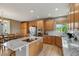 Beautiful kitchen with granite countertops, stainless appliances, wood cabinets, and a center island at 14682 W Amherst Pl, Lakewood, CO 80228