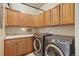 Laundry room features modern washer and dryer, cabinets, countertops and sink at 14682 W Amherst Pl, Lakewood, CO 80228