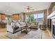 Spacious living room with hardwood floors, large windows with mountain views, and comfortable seating arrangement at 14682 W Amherst Pl, Lakewood, CO 80228