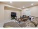 Finished basement offers a living room with a large sectional, TV, and coffee table at 14682 W Amherst Pl, Lakewood, CO 80228