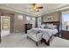 Comfortable bedroom featuring a large bed with patterned bedding, a dresser, and ample natural light from multiple windows at 14682 W Amherst Pl, Lakewood, CO 80228
