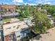 This aerial shot showcases a charming neighborhood with brick buildings, lush trees, and a peaceful ambiance at 22 E Bayaud Ave, Denver, CO 80209