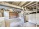 Unfinished basement featuring concrete floors, exposed brick walls, utility sink and washer/dryer at 22 E Bayaud Ave, Denver, CO 80209