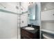 Updated bathroom with white subway tile shower and a stylish dark wood vanity and mirror at 22 E Bayaud Ave, Denver, CO 80209