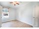Light-filled bedroom with neutral walls, hardwood floors, and a window offering ample natural light at 22 E Bayaud Ave, Denver, CO 80209