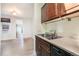 Galley kitchen with dark wood cabinets and stainless steel sink, and an entry view at 22 E Bayaud Ave, Denver, CO 80209