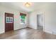Spacious living room featuring hardwood floors, a door to the outside, and a large window for natural light at 22 E Bayaud Ave, Denver, CO 80209