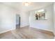 Well-lit living room boasting hardwood floors, a pass-through window to the kitchen, and ample natural light at 22 E Bayaud Ave, Denver, CO 80209
