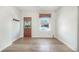Bright living room with hardwood floors and a window bringing in natural light, complemented by modern wall hooks at 22 E Bayaud Ave, Denver, CO 80209