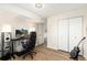 Bedroom with spacious closet, hardwood floors, computer and modern lighting at 7665 E Eastman Ave # 107B, Denver, CO 80231