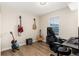Bedroom featuring beautiful guitars mounted to the wall and desk setup at 7665 E Eastman Ave # 107B, Denver, CO 80231
