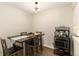 Features a modern dining table, room for four, and a rustic coffee cart with microwave at 7665 E Eastman Ave # 107B, Denver, CO 80231