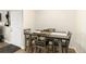 A simple dining room features a dark table and wooden chairs at 7665 E Eastman Ave # 107B, Denver, CO 80231
