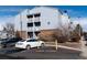 Exterior of multi-story condominium building with parking, landscaping and exterior walkways at 7665 E Eastman Ave # 107B, Denver, CO 80231