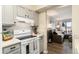 Well-equipped kitchen with gray cabinetry and stainless appliances open to living space at 7665 E Eastman Ave # 107B, Denver, CO 80231