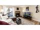 Comfortable living room with a brick fireplace, plush seating, a TV, and lots of natural light at 7665 E Eastman Ave # 107B, Denver, CO 80231