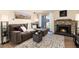Inviting living room with a stone fireplace, a comfortable grey couch, and lots of natural light at 7665 E Eastman Ave # 107B, Denver, CO 80231
