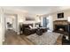 Comfortable living room with a stone fireplace, plush seating, a TV, and lots of natural light at 7665 E Eastman Ave # 107B, Denver, CO 80231