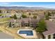 Aerial view of a condo complex with a pool, landscaping, and mountain views at 695 Manhattan Dr # 5, Boulder, CO 80303