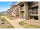 Exterior of the condo featuring stairs, balconies, and mature trees at 695 Manhattan Dr # 5, Boulder, CO 80303