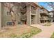 Exterior of the condo featuring stairs, balconies, and mature trees at 695 Manhattan Dr # 5, Boulder, CO 80303