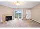 Living room featuring a fireplace, sliding glass doors, and neutral carpet at 695 Manhattan Dr # 5, Boulder, CO 80303