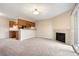 View of a living room with fireplace, neutral carpet, and sliding glass doors at 695 Manhattan Dr # 5, Boulder, CO 80303