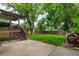 Landscaped backyard showcasing a spacious patio, lush green lawn, and mature trees for a serene outdoor experience at 8410 Gray St, Arvada, CO 80003