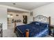 Finished bedroom with an iron frame bed, carpeting, and baseboard trim at 8410 Gray St, Arvada, CO 80003
