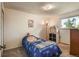 Cozy bedroom featuring a twin bed and window allowing for lots of natural light at 8410 Gray St, Arvada, CO 80003