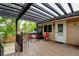 Wooden deck featuring a pergola and outdoor furniture with a view of the backyard at 8410 Gray St, Arvada, CO 80003