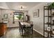 Charming dining area with wood-look flooring, table with four chairs, and backyard views at 8410 Gray St, Arvada, CO 80003