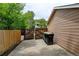 Driveway to the side of the home with a gated wooden fence and trash receptacles at 8410 Gray St, Arvada, CO 80003