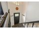 Welcoming entryway with dark wood door, staircase, and stylish light fixture at 8410 Gray St, Arvada, CO 80003