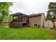 Back exterior featuring a deck with a pergola, a well-maintained lawn, and an adjacent storage shed at 8410 Gray St, Arvada, CO 80003